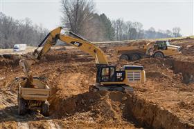 Pottstown Division: A Caterpillar 349F works the cut with Caterpillar haul trucks moving material. 