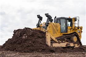 Pottstown Division: A Caterpillar D8T strips soil.