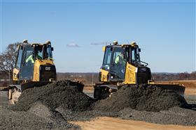 Pottstown Division: Two Caterpillar dozers grade stone on a pad. 