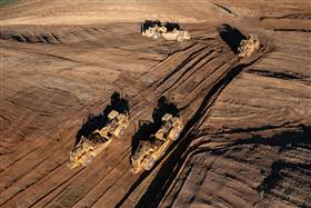 Landis C. Deck & Sons Division: Four Caterpillar scrapers work a cut on a site. 