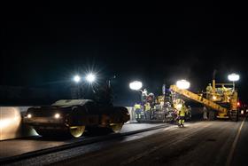 Haines & Kibblehouse, Inc.: A Volvo roller compacts fresh black top on I-295 as the paving spread continues along the highway. 