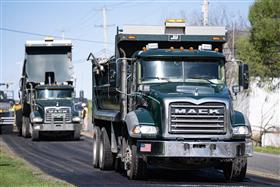 Landis C. Deck & Sons Division: Two Landis C. Deck & Sons's Mack dump trucks working with the paving crew. 